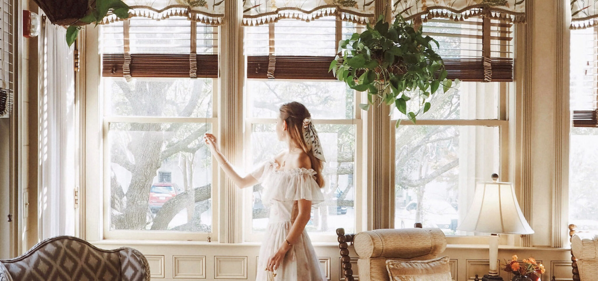 woman looking out window in sunroom