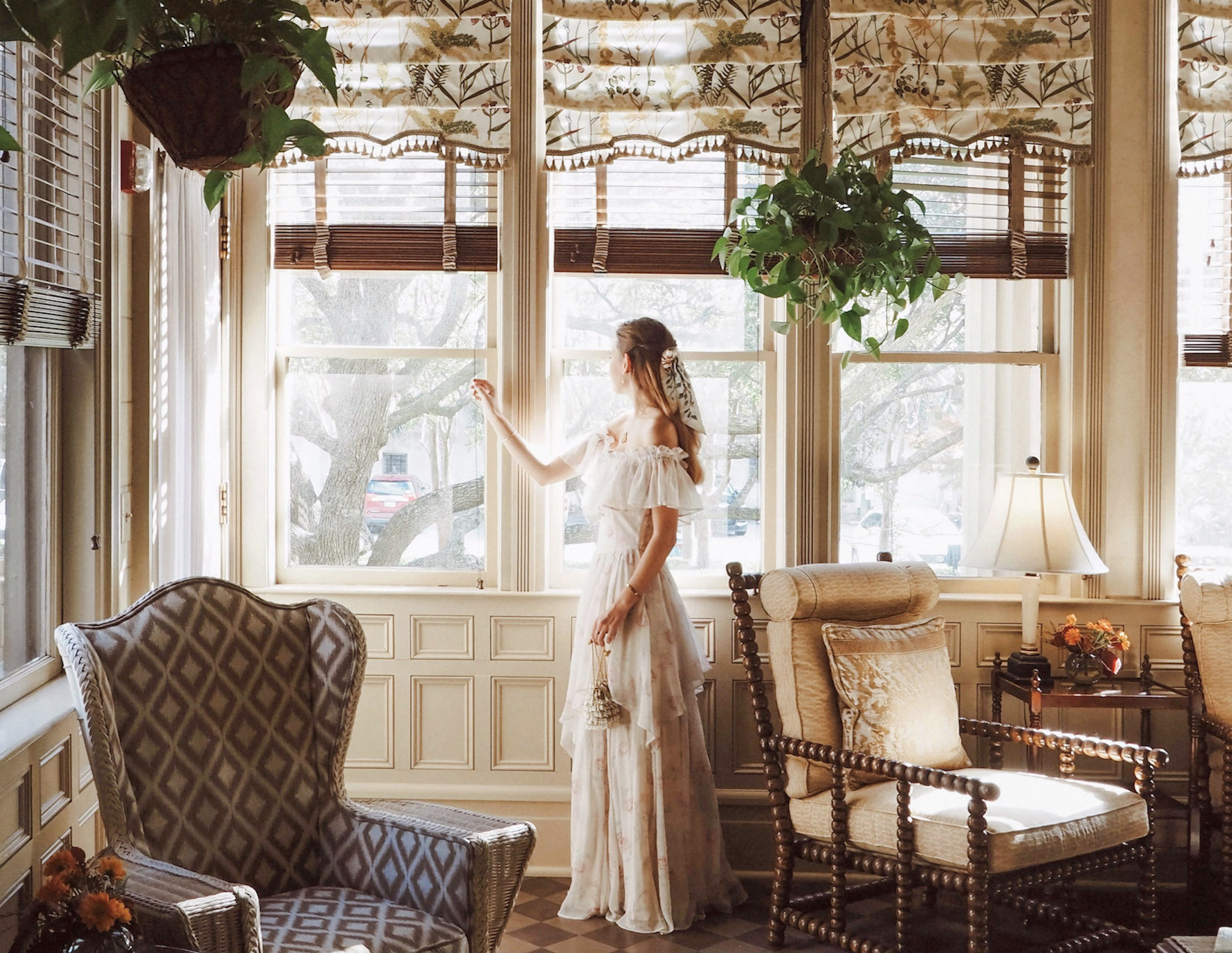 woman looking out window in sunroom