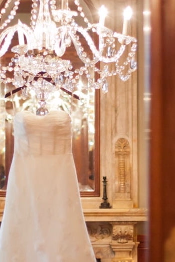 wedding dress hanging from chandelier