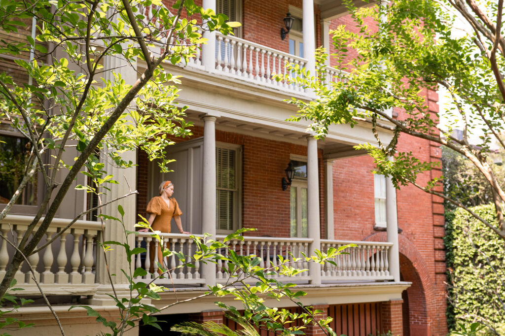 Woman enjoying the porch at Wentworth Mansion